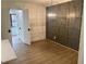 Dining room featuring paneled walls, modern lighting, and new floors at 145 Amherst Nw Pl, Atlanta, GA 30327