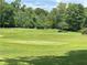 Scenic view of the immaculate golf course with flags and carefully manicured greenery at 145 Amherst Nw Pl, Atlanta, GA 30327
