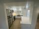 Updated kitchen with stainless steel appliances, white cabinets, and a breakfast bar at 145 Amherst Nw Pl, Atlanta, GA 30327