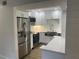 Bright kitchen features stainless steel appliances, white cabinetry and stone countertops at 145 Amherst Nw Pl, Atlanta, GA 30327