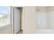Bright bathroom featuring a shower and a window with blinds at 326 Lauren Dr, Fairburn, GA 30213