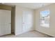 Bright bedroom with white doors, a window, and neutral walls at 326 Lauren Dr, Fairburn, GA 30213