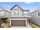 Charming two-story home with a brick-accented garage and inviting curb appeal in a well-maintained neighborhood at 326 Lauren Dr, Fairburn, GA 30213