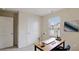 Bright home office with a desk, chair, window, and neutral walls, creating a productive workspace at 326 Lauren Dr, Fairburn, GA 30213