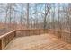 The back deck is made of natural wood, with railings, and a view of a wooded area at 3865 Whitney Pl, Duluth, GA 30096