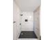 Bathroom featuring a tiled walk-in shower, modern fixtures, and black decorative floor tiles at 3865 Whitney Pl, Duluth, GA 30096