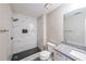 Bathroom featuring a tiled walk-in shower, granite countertop vanity, and modern fixtures at 3865 Whitney Pl, Duluth, GA 30096
