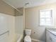 Bathroom featuring a tub and shower, toilet, granite countertop vanity, and a window at 3865 Whitney Pl, Duluth, GA 30096
