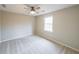 Bedroom featuring neutral carpet, a ceiling fan, and a window at 3865 Whitney Pl, Duluth, GA 30096