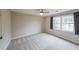 Neutral bedroom with carpet flooring and a large window at 3865 Whitney Pl, Duluth, GA 30096