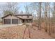 Charming two-story home featuring a two-car garage and a cozy front porch nestled on a hillside at 3865 Whitney Pl, Duluth, GA 30096