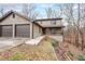 Charming two-story home featuring a two-car garage and a cozy front porch nestled on a hillside at 3865 Whitney Pl, Duluth, GA 30096