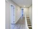 Upstairs hallway with wood-look flooring, white trim and railing, and a view of the stairs at 3865 Whitney Pl, Duluth, GA 30096