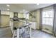 Bright kitchen featuring white cabinets, granite countertops, an island and modern stainless steel appliances at 3865 Whitney Pl, Duluth, GA 30096