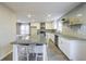 Bright kitchen featuring white cabinets, granite countertops, an island and modern stainless steel appliances at 3865 Whitney Pl, Duluth, GA 30096