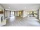 Large open concept living room featuring a fireplace, view to kitchen, and large windows at 3865 Whitney Pl, Duluth, GA 30096