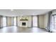 Spacious living room featuring hard surface floors and a white painted brick fireplace at 3865 Whitney Pl, Duluth, GA 30096