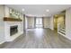Large open concept living room featuring a fireplace, view to staircase, and large windows at 3865 Whitney Pl, Duluth, GA 30096