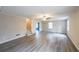 The living room has gray floors, stairs, and a view to another room with a blue accent wall at 3865 Whitney Pl, Duluth, GA 30096