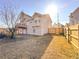 View of the home's backyard with a wooden fence and grassy area on a sunny day at 5546 Wellborn Creek Dr, Lithonia, GA 30058