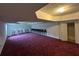 Large finished basement with carpeted floors and neutral walls at 5546 Wellborn Creek Dr, Lithonia, GA 30058