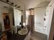Well-lit bathroom featuring a tub-shower combo, vanity with sink, and window at 5546 Wellborn Creek Dr, Lithonia, GA 30058