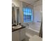 Cozy bathroom features a tub with shower and window providing natural light over the vanity at 5546 Wellborn Creek Dr, Lithonia, GA 30058
