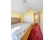 A bedroom featuring vaulted ceilings, yellow walls, and carpet at 5546 Wellborn Creek Dr, Lithonia, GA 30058
