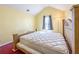 A bedroom with yellow walls, vaulted ceilings, carpet and a wooden bed frame at 5546 Wellborn Creek Dr, Lithonia, GA 30058