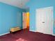 A bedroom features blue walls, white trim, carpet and a closet at 5546 Wellborn Creek Dr, Lithonia, GA 30058