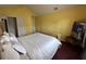 Spacious bedroom with a vaulted ceiling, featuring a comfortable bed and bright, yellow walls at 5546 Wellborn Creek Dr, Lithonia, GA 30058