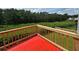 Back deck overlooking serene greenery, creating a peaceful outdoor space, and a vibrant red surface at 5546 Wellborn Creek Dr, Lithonia, GA 30058