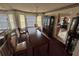 Dining room features a long wood table, carpet, decorative china cabinet, and chandelier at 5546 Wellborn Creek Dr, Lithonia, GA 30058