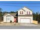 Inviting two-story home with a two car garage and manicured lawn at 5546 Wellborn Creek Dr, Lithonia, GA 30058
