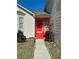 Charming home featuring a bright red front door and quaint walkway, with fresh landscaping at 5546 Wellborn Creek Dr, Lithonia, GA 30058