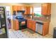 A kitchen featuring warm wood cabinets, stainless steel appliances and linoleum tile floors at 5546 Wellborn Creek Dr, Lithonia, GA 30058
