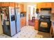 Cozy kitchen with stainless steel appliances, light wood cabinets, and decorative flooring at 5546 Wellborn Creek Dr, Lithonia, GA 30058