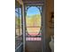 View through the decorative screen door onto the wood deck and wooded backyard at 5546 Wellborn Creek Dr, Lithonia, GA 30058