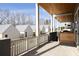 Scenic balcony with wooden railing and ceiling, providing an inviting outdoor space with views of nearby homes at 1235 Lupo Loop, Palmetto, GA 30268