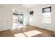 Bright bedroom features hardwood floors, large windows and doors with views of the outdoors at 1235 Lupo Loop, Palmetto, GA 30268