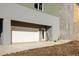 Side angle view of the house with a garage, exterior lighting, and a spacious driveway at 1235 Lupo Loop, Palmetto, GA 30268
