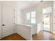 Bright hallway with hardwood floors, a window with a view, white door, and white walls and trim at 1235 Lupo Loop, Palmetto, GA 30268