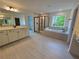 Beautiful bathroom featuring double sink vanity, soaking tub, and a walk-in shower with glass door at 3677 Thornhill Ct, Douglasville, GA 30135