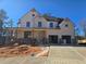 Two-story home with a brick and siding exterior, front porch, and two-car garage at 3677 Thornhill Ct, Douglasville, GA 30135