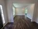 Bright living room featuring hardwood floors, white trim, and plenty of natural light at 3677 Thornhill Ct, Douglasville, GA 30135