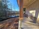 Covered porch with stone accents, a wooden support beam and a view of a tree-lined lot at 3677 Thornhill Ct, Douglasville, GA 30135