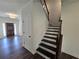 Staircase with dark treads and white risers, leading to the upper level of the home at 3677 Thornhill Ct, Douglasville, GA 30135