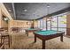 Resident game room with pool tables, bar seating, lounge area, and televisions at 1280 W Peachtree Nw St # 3414, Atlanta, GA 30309