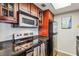 Updated kitchen with stainless steel appliances, granite countertops, and cherry wood cabinetry at 1280 W Peachtree Nw St # 3414, Atlanta, GA 30309