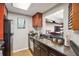 Well-equipped kitchen featuring dark cabinetry, granite countertops, and modern appliances for cooking at 1280 W Peachtree Nw St # 3414, Atlanta, GA 30309